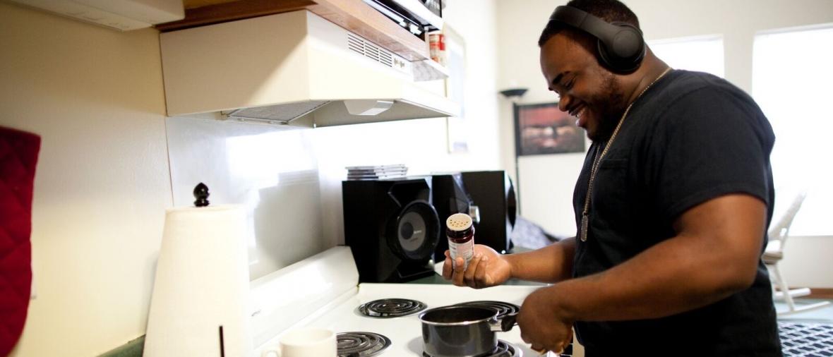 Young man cooking at a stove